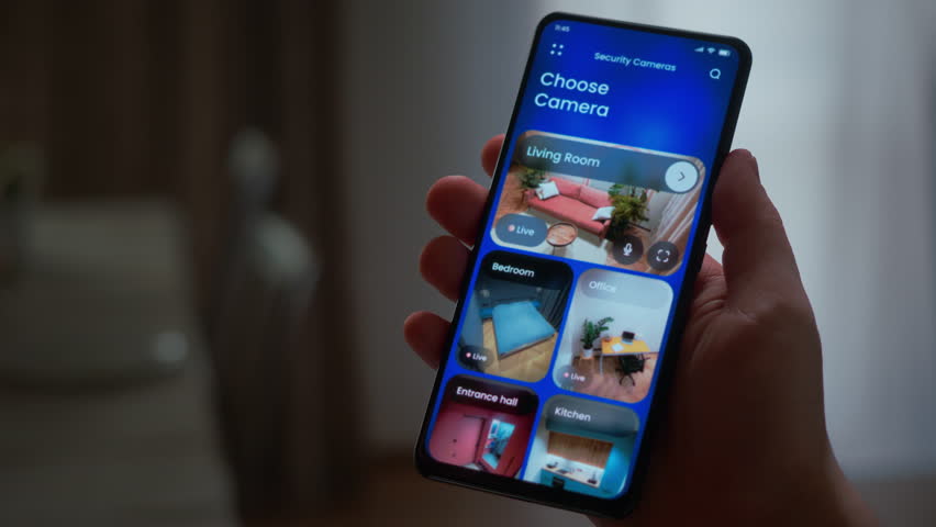 Monitoring security cameras on smartphone application. Smart home cctv video on a house security system app.