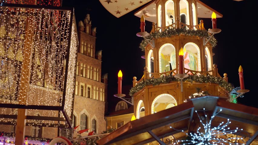 Christmas fair at night with illuminated gnome figures riding on toy train, festive lights and holiday atmosphere at night city. Christmas market in Wroclaw, Poland