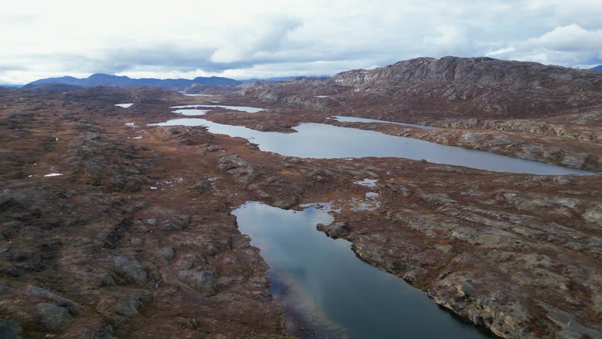 Flyover rocky arctic tundra lakes, Arctic Circle Trail in Greenland