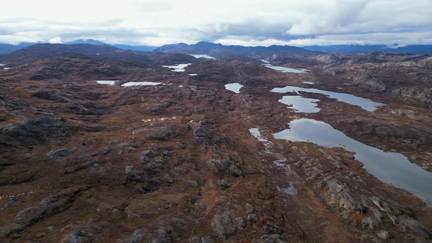 Aerial view of rugged remote rocky tundra landscape in Greenland