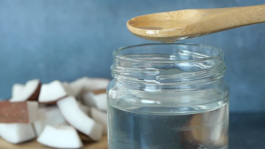  spoon pick coconut oil from a jar 