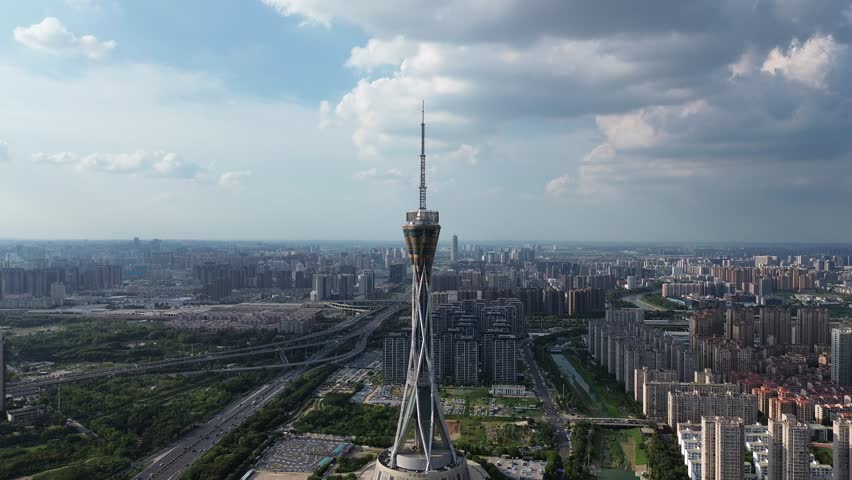 Aerial view of Zhongyuan Tower (Henan Radio and TV Tower) in Zhengzhou, China, on a sunny summer afternoon, with the city