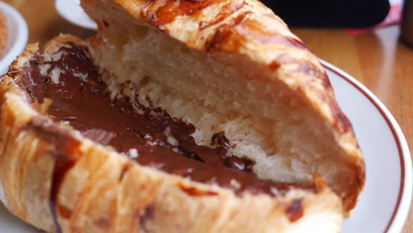 Croissant filled with chocolate served at bakery in afternoon