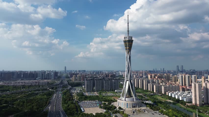 Aerial view of Zhongyuan Tower (Henan Radio and TV Tower) in Zhengzhou, China, on a sunny summer afternoon, with the city