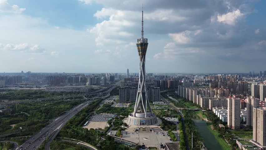 Aerial view of Zhongyuan Tower (Henan Radio and TV Tower) in Zhengzhou, China, on a sunny summer afternoon, with the city