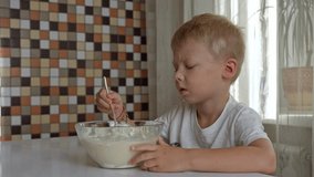 In a cozy kitchen, a mother and her young son enthusiastically prepare pancakes. The little boy focuses on mixing the batter, while they share smiles and laughter, creating cherished family moments. - Powered by Shutterstock - Get 15% off with code: PIKWIZARD15