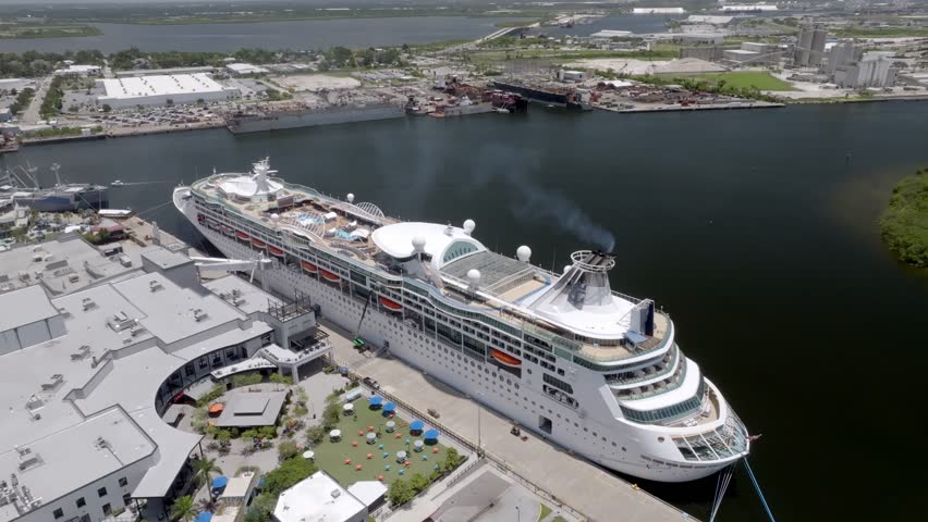 Cruise ship docked in Tampa, Florida with drone video moving down.