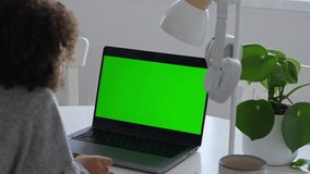 Primary school Student African American child with headphones using laptop green screen chroma key. Distance learning online education. Schoolboy girl studying at home with digital tablet computer and - Powered by Shutterstock - Get 15% off with code: PIKWIZARD15