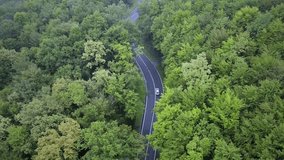 Aerial view of white electric car on eco forest road with animated battery level draining. Motion graphic - Powered by Shutterstock - Get 15% off with code: PIKWIZARD15