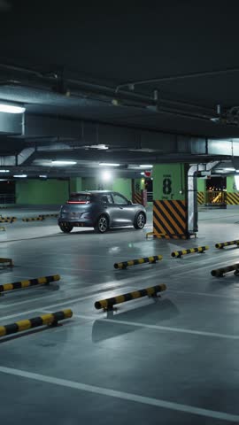 Modern silver electric car driving in underground parking