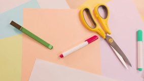 Overhead view of art supplies and rotating paint palette on pastel-colored desk, bright lighting - Powered by Shutterstock - Get 15% off with code: PIKWIZARD15