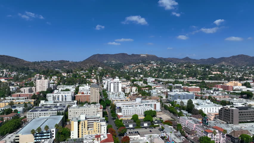 Aerial tracking shot overlooking the Hollywood cityscape of Los Angeles, USA