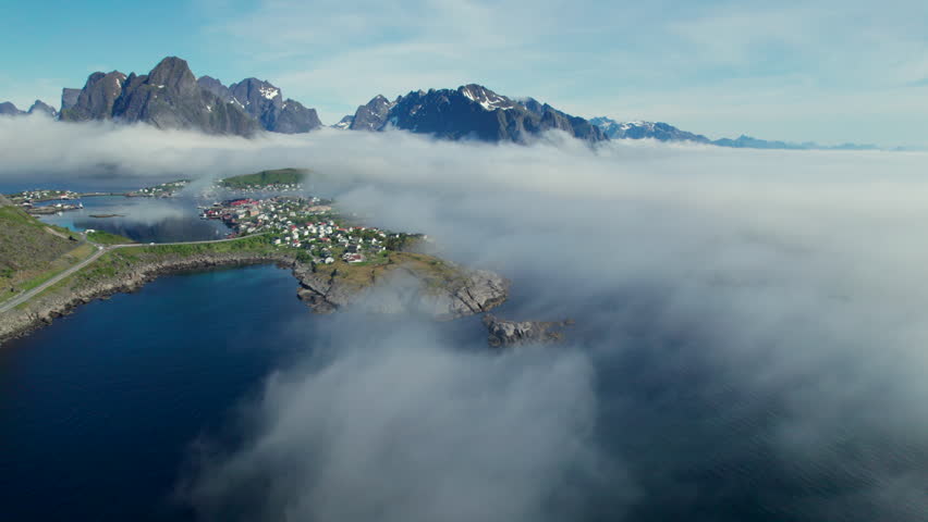 Aerial view of the village of Reine surrounded by sea and fog in the Lofoten Islands, Norway