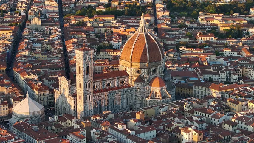 Aerial view of Florence Cathedral, bathed in warm sunlight, standing majestically amidst the city