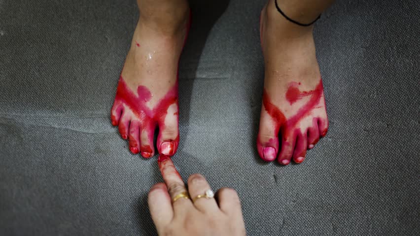 festive occasion with hands painting red on child’s feet