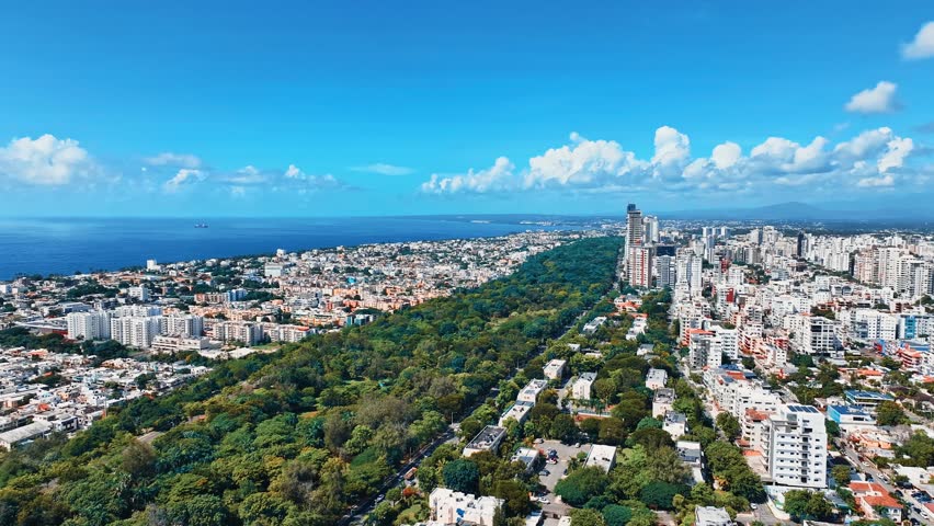 Drone view of a stunning oceanfront city. Dominican Republic, capital of Santo Domingo, city center. Caribbean coastline. City park. Old town. A realistic aerial view of the capital