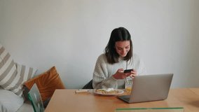 A young woman works on her laptop while having a healthy breakfast at home. She enjoys a poached egg with avocado toast and orange juice. - Powered by Shutterstock - Get 15% off with code: PIKWIZARD15