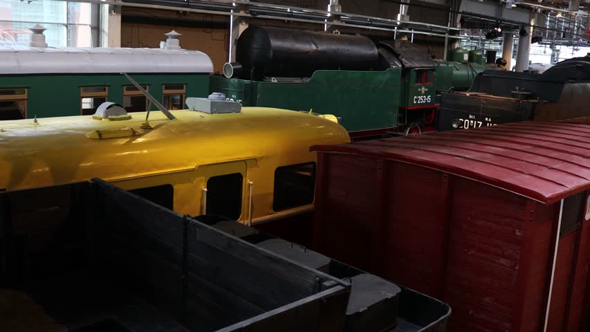 A row of trains standing idle next to each other, ready for their next journey.
