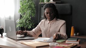 Professional businesswoman analyzing financial charts, working on laptop, and talking on the phone - Powered by Shutterstock - Get 15% off with code: PIKWIZARD15