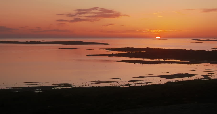 Enjoy a stunning sunset over the coastal sea of Sweden, capturing serene beauty in vibrant colors