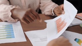 Diverse businesswomen discussing financial statistics and marketing strategy in a modern office - Powered by Shutterstock - Get 15% off with code: PIKWIZARD15