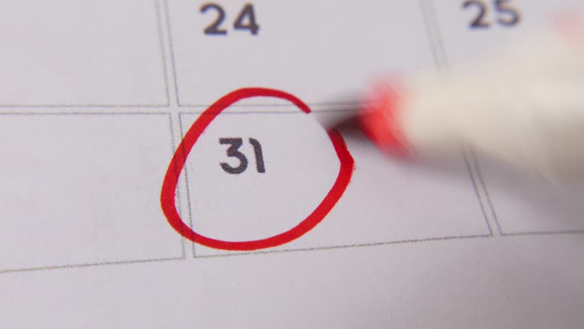 The 31st on the calendar is circled in red marker in a close-up macro shot on a white page, symbolizing an important day or reminder.
