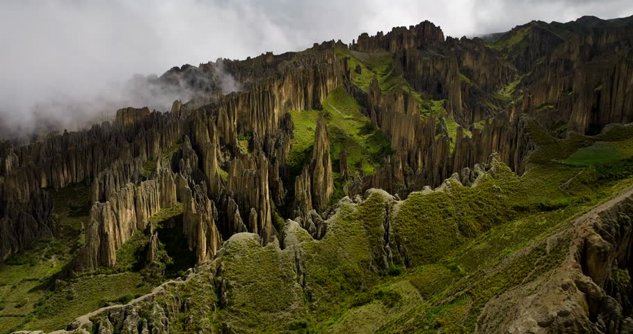 Rock formations in Valle de las Animas, Valley of the Souls, clouds and fog over unique geological spires near La Paz, Bolivia. Aerial drone panoramic view