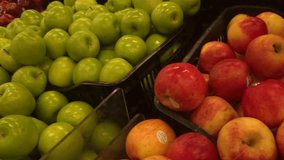 Green and red apples stacked up in an aisle in a supermarket. Recorded in Lima, Peru. - Powered by Shutterstock - Get 15% off with code: PIKWIZARD15