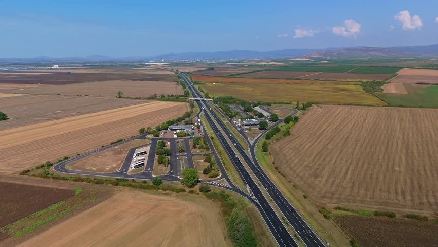 Aerial view of resting places on the two sides of the M3 motorway with moving traffic near Karácsond in Hungary.