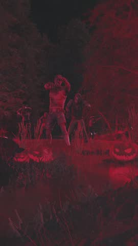 A musician performs energetically on a dark stage, illuminated by intense red lights during a live concert or music festival. The video has a grainy, vintage feel.