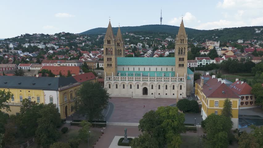 Aerial view of Pécs Cathedral, highlighting its grand entrance, twin towers, and ornate architectural details