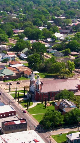 A vertical drone clip focusing on the historic St. Peter Catholic Church in downtown New Iberia, Louisiana. This clip is ideal for tourism, cultural heritage, and establishing shots.