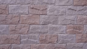 Finished section of a facade with decorative stone tiles installed on the wall. Close-up view of completed masonry work after exterior renovation. - Powered by Shutterstock - Get 15% off with code: PIKWIZARD15
