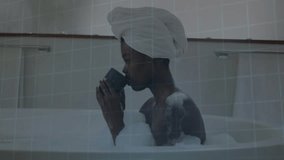 Woman sipping green mug in bubble bath with HUD grid overlay starting scanning wellness biometrics. Relaxation, spa, digital, biometric, health, serenity, technology - Powered by Shutterstock - Get 15% off with code: PIKWIZARD15