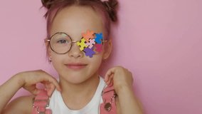 The girl decorated her glasses with multicolor puzzles as a sign of support for children with autism spectrum disorder. - Powered by Shutterstock - Get 15% off with code: PIKWIZARD15