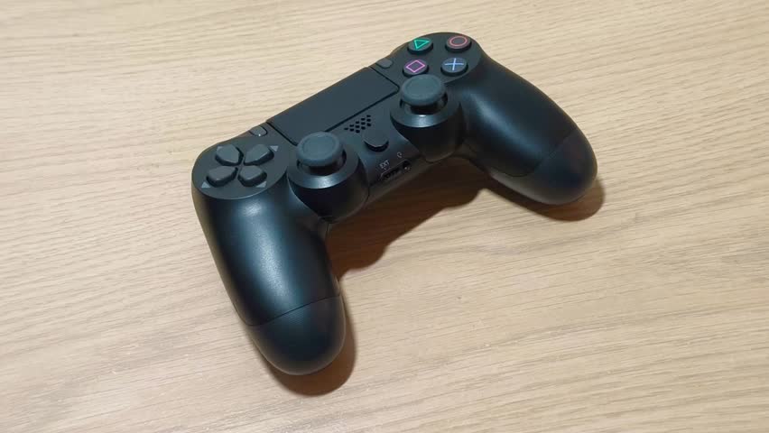 Immerse yourself in the gaming zone with this sleek black wireless gamepad ready to conquer virtual worlds, perfect for showcasing interactive entertainment and competitive esports - Powered by Shutterstock - Get 15% off with code: PIKWIZARD15