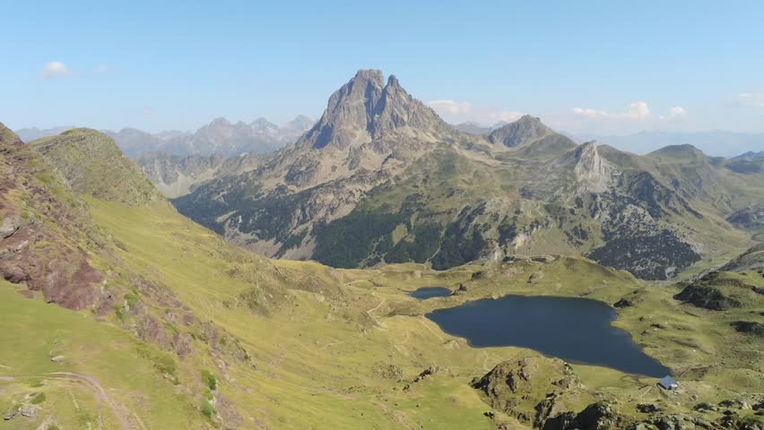Scenic aerial shot of turquoise mountain lake and snowy peak, Pyrenees, France