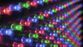Detailed macro perspective of a pulsing RGB light panel, showing the grid of red, green, and blue diodes flashing in a coordinated rhythm, with visible dust particles on the electronic surface. - Powered by Shutterstock - Get 15% off with code: PIKWIZARD15