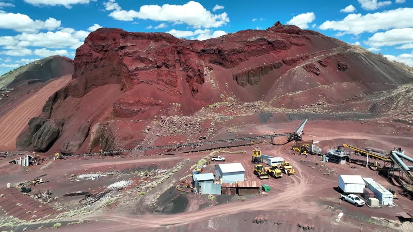 Aerial view of the stark contrast between the red mountain and the industrial mining site, a scene of human intervention, Flagstaff, Arizona, United States.