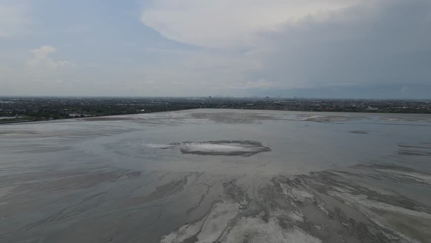 Aerial view of the vast muddy landscape meeting the city