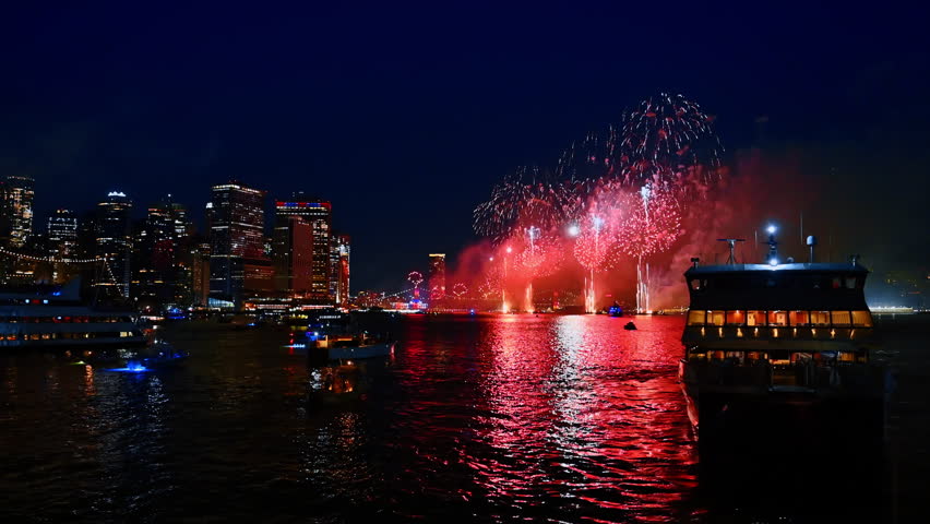 Fireworks over Manhattan skyline at night. Bright fireworks over the New York Manhattan skyline and river.