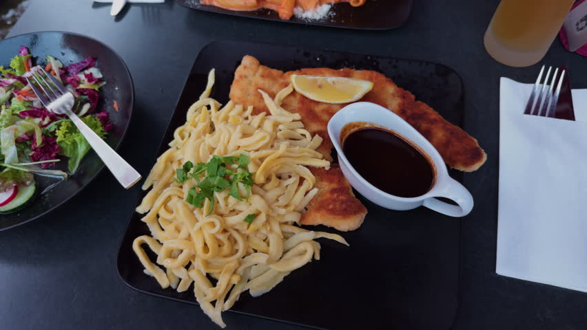 Experience a Delightful Platter featuring Fried Fish, Noodles, Fresh Salad, and Savory Sauce for a tasty treat