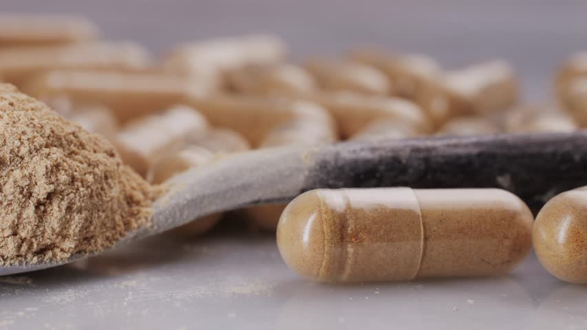 Ashwagandha Indian Ginseng Powder in White Bowl isolated on white background, superfood close up. 