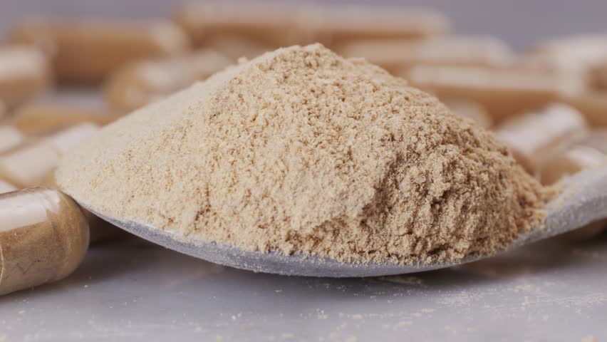 Ashwagandha Indian Ginseng Powder in White Bowl isolated on white background, superfood close up. 