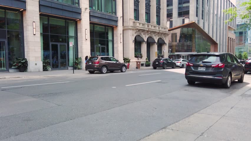 MONTREAL, CANADA - AUGUST 10, 2025: A stroll along the major street in Montreal, Saint Jacques Street. Modern skyscrapers and the old architecture. It is a major financial centre of the city.