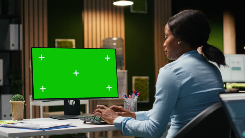 Isolated chroma key on desktop pc with black analyst analyzing KPI metrics, applying a strategic mindset to business development plans. Support innovation and goals achievement. Camera B.