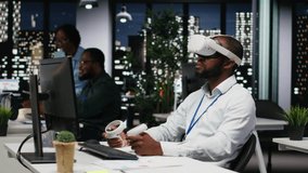Young black businessman using virtual reality headset and other devices to build a strategy, forecasting projections and documenting risk assessment for success. Business goals. Camera B. - Powered by Shutterstock - Get 15% off with code: PIKWIZARD15