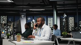 African american consultant makes important phone call after hours, contacting senior consultant to share business growth ideas and investment opportunities on a secure telephone line. Camera A. - Powered by Shutterstock - Get 15% off with code: PIKWIZARD15