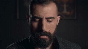 Cinematic close-up portrait of a man with a thick, well-groomed beard and intense gaze. High contrast, moody lighting. - Powered by Shutterstock - Get 15% off with code: PIKWIZARD15