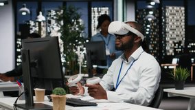 Black businessman using VR headset and gadgets to draft a project plan, engaged in forecasting projections and documenting risk assessment results. Solve tasks with virtual reality. Camera B. - Powered by Shutterstock - Get 15% off with code: PIKWIZARD15